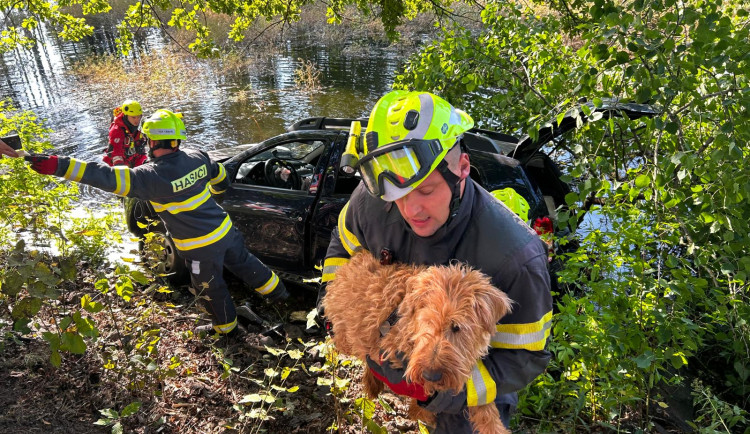 Auto sjelo do rybníka. Hasiči zachránili řidičku i psa